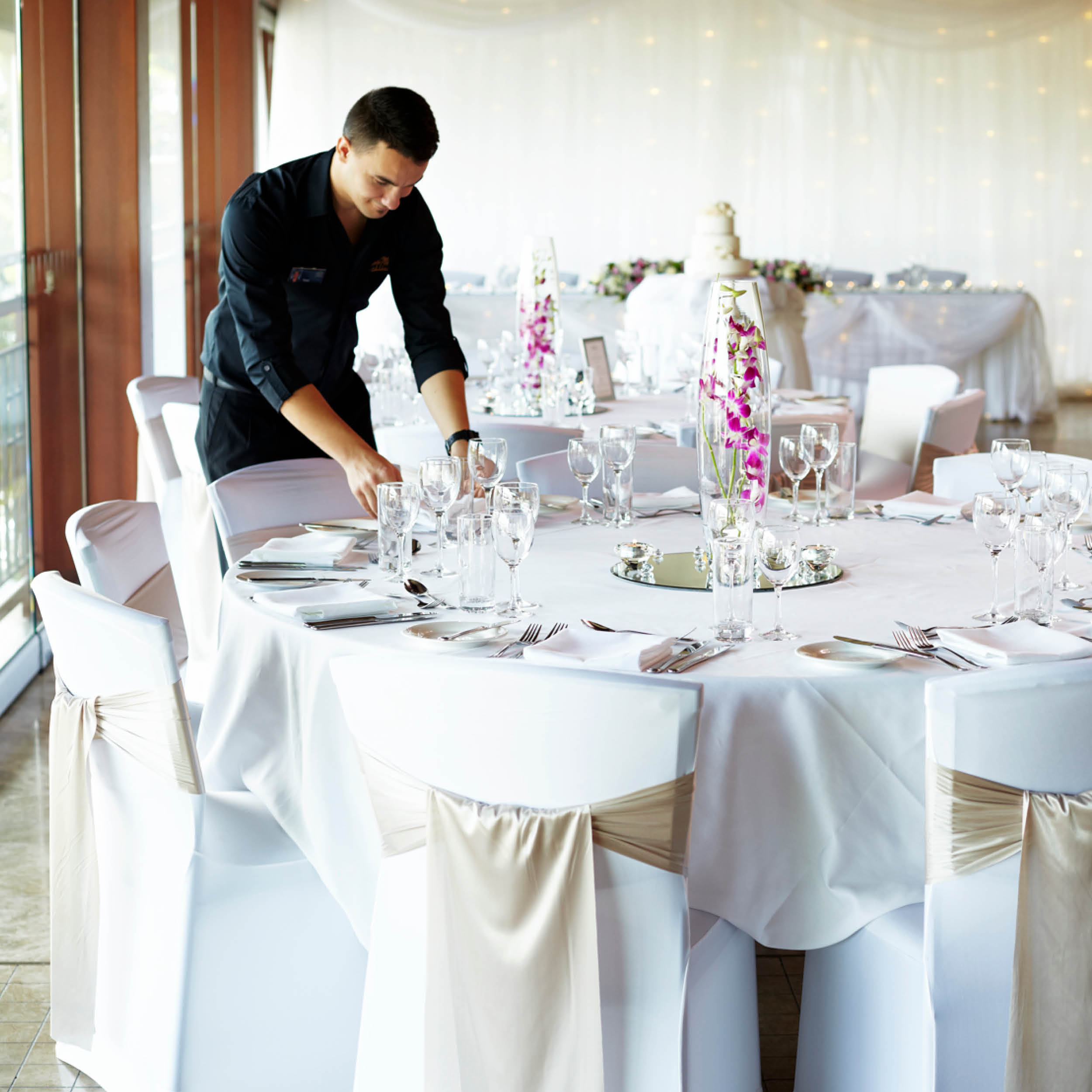 Function staff setting up table setting for private function
